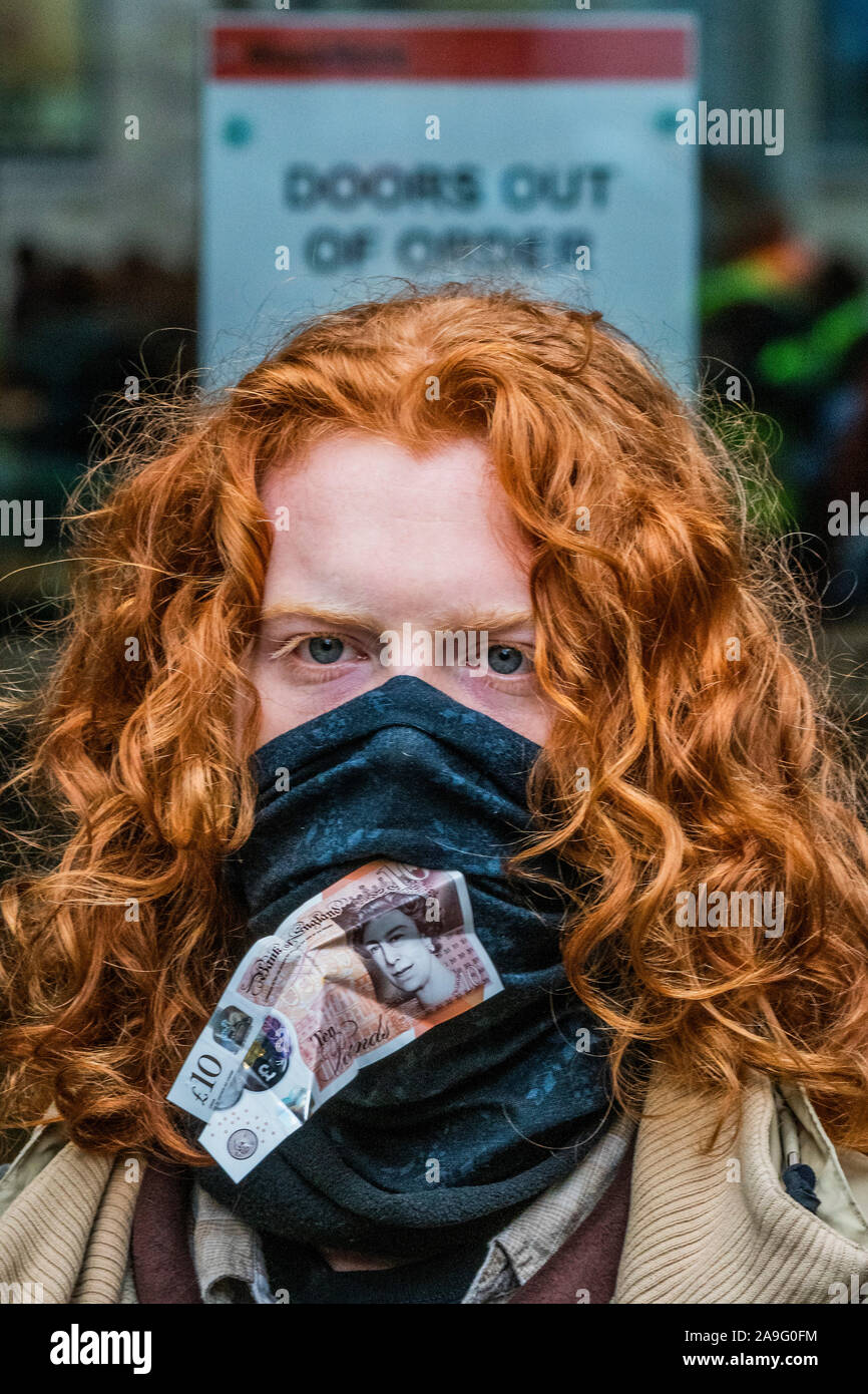 London, UK. 15th Nov 2019. You cant eat money - Extinction Rebellion UK  gather in front of the investment firm BlackRock to engage in a nonviolent  protest to challenge the firm as '