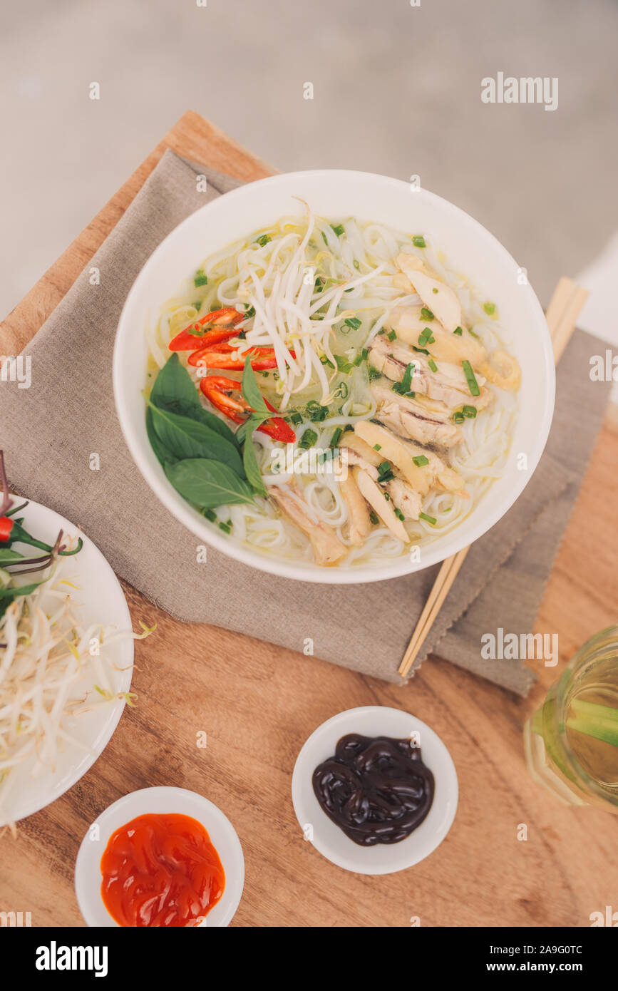 Traditional vietnamese noodle soups pho in bowls, concrete background. Vietnamese beef soup pho
