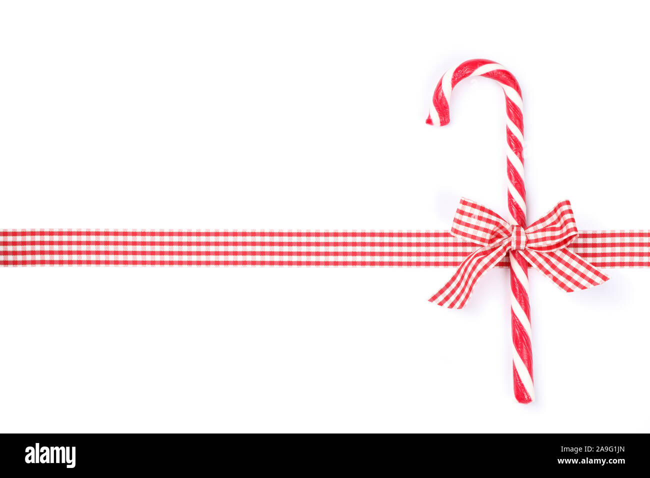 Sweet candy cane with bow isolated on white background Stock Photo - Alamy