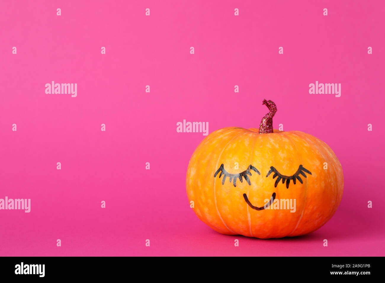 Pumpkin with smile on pink background, space for text Stock Photo - Alamy
