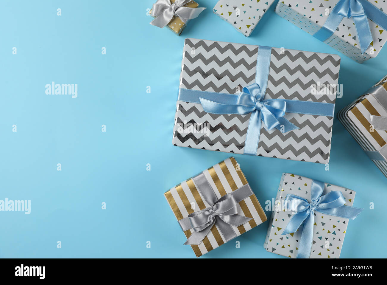Different gift boxes on blue background, copy space Stock Photo