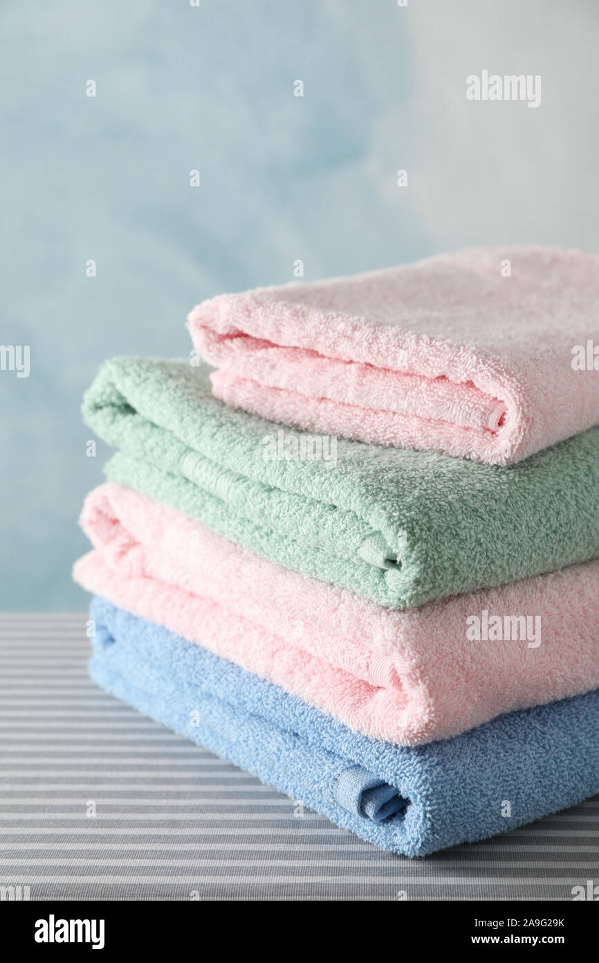 Stack of clean towels on ironing board, copy space Stock Photo Alamy