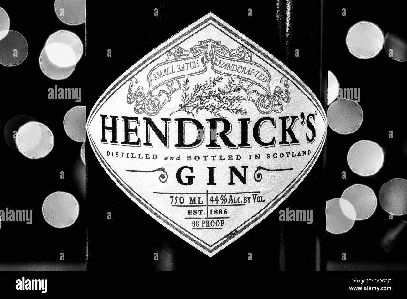 Hendrick's Gin bottle in front of Christmas lights. Hendrick's Gin has been created by William Grant & Sons at the Girvan distillery since 1999. Stock Photo