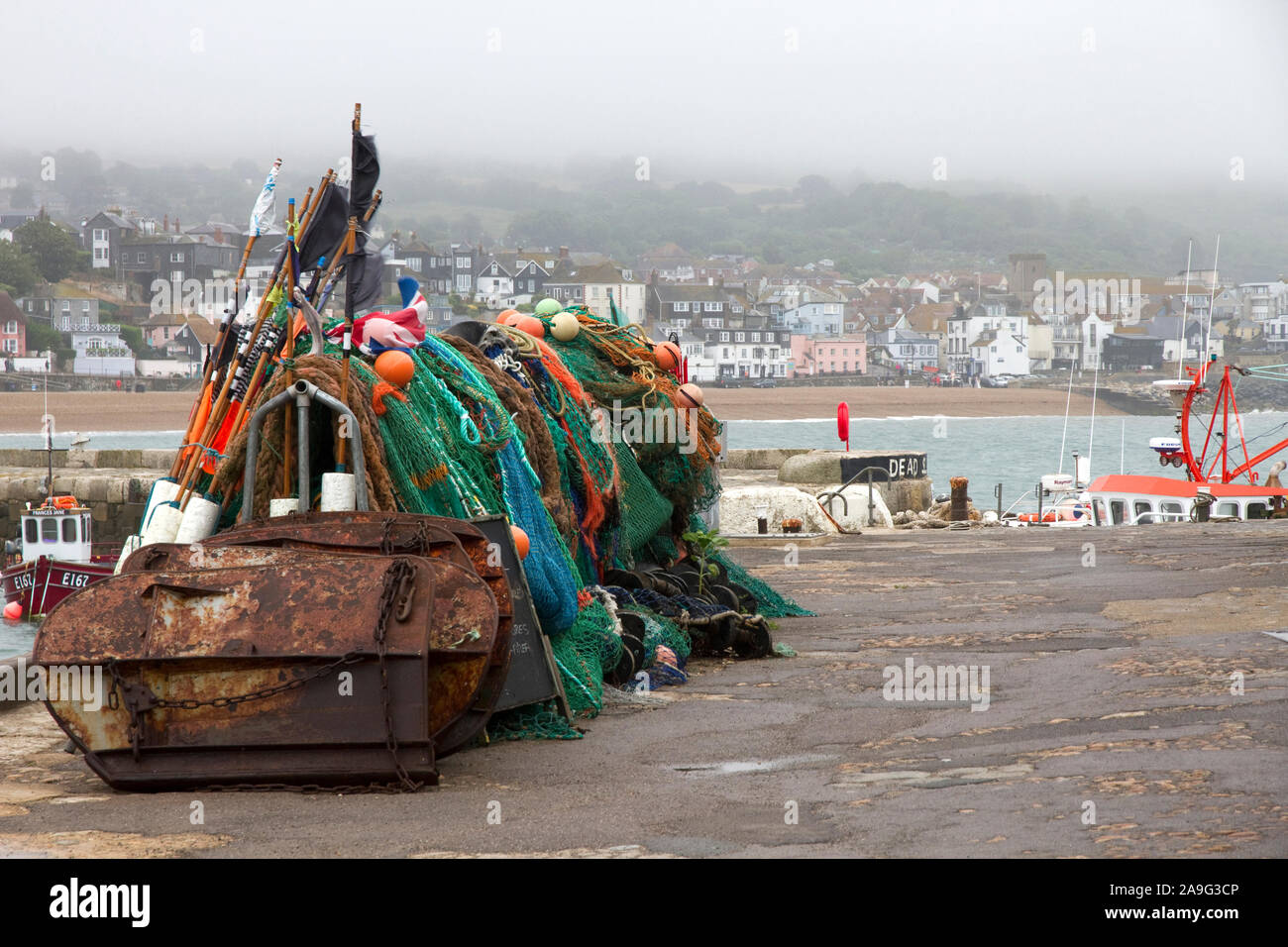 Misty summer day. The Cobb, Harbour and seafront, Lyme Regis, Dorset, England, UK Stock Photo