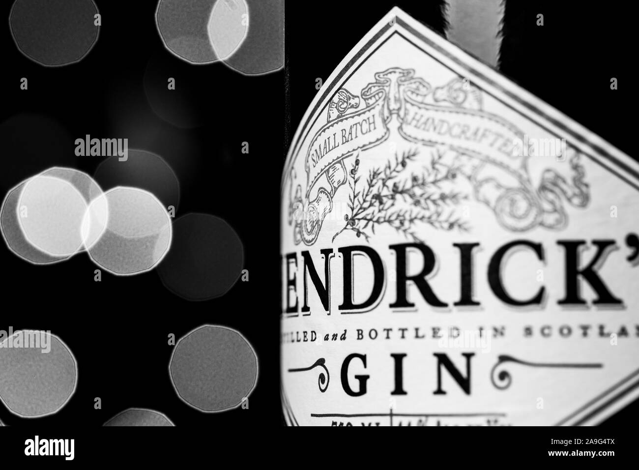 Hendrick's Gin bottle in front of Christmas lights. Hendrick's Gin has been created by William Grant & Sons at the Girvan distillery since 1999. Stock Photo