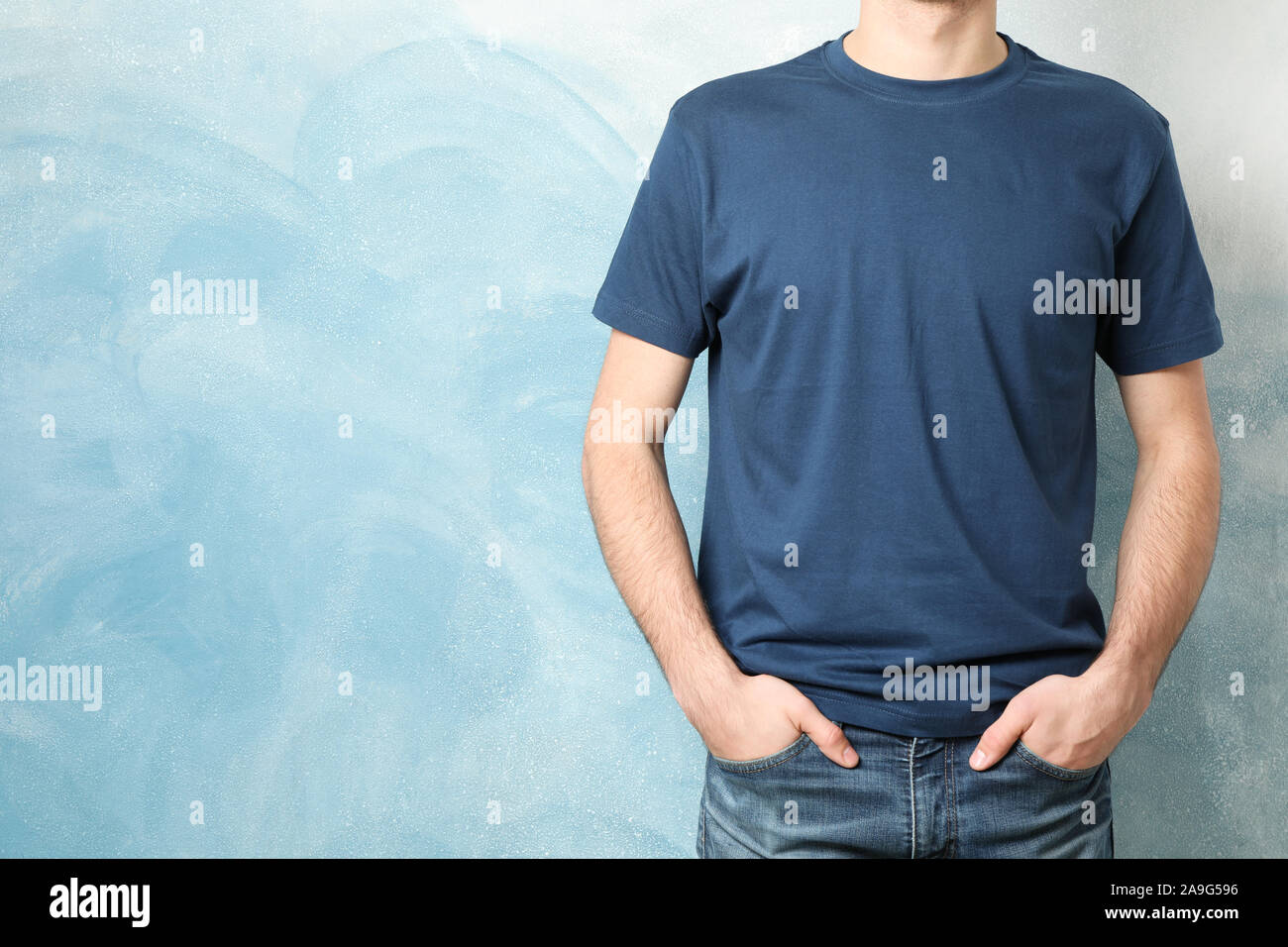 Men in blank blue t-shirt against color background, space for text Stock  Photo - Alamy