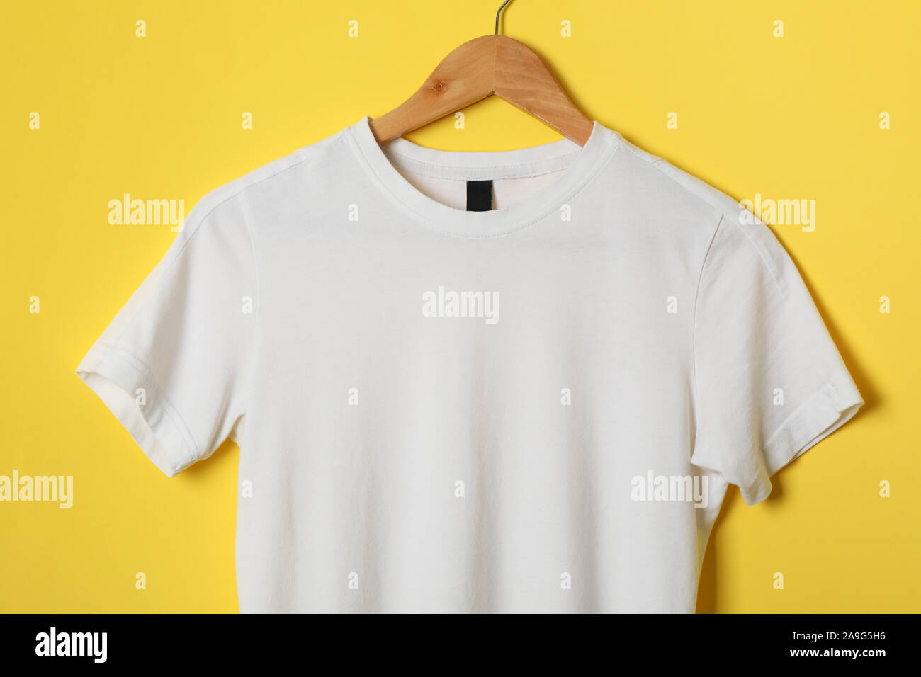 Download Hanger With Blank White T Shirt On Yellow Background Space For Text Stock Photo Alamy