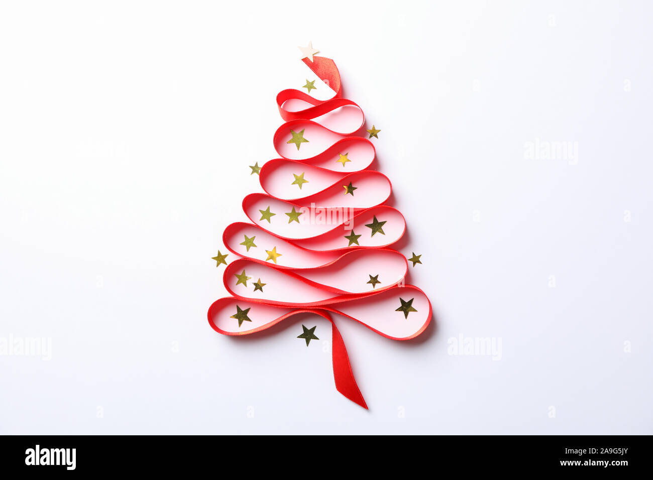 Christmas tree made from red ribbon and glitter on white background ...