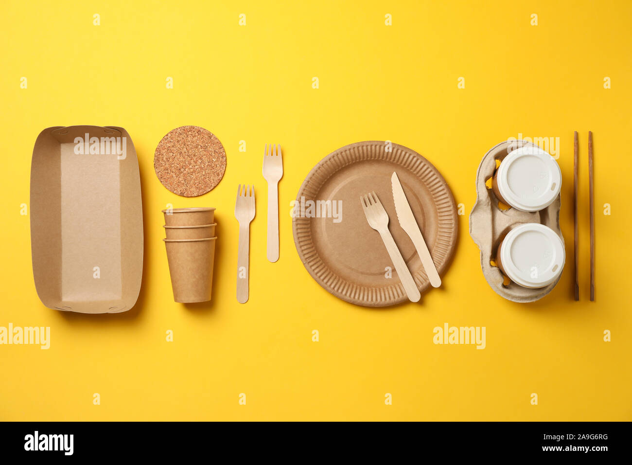 Flat lay with eco - friendly tableware on yellow background, space for text Stock Photo