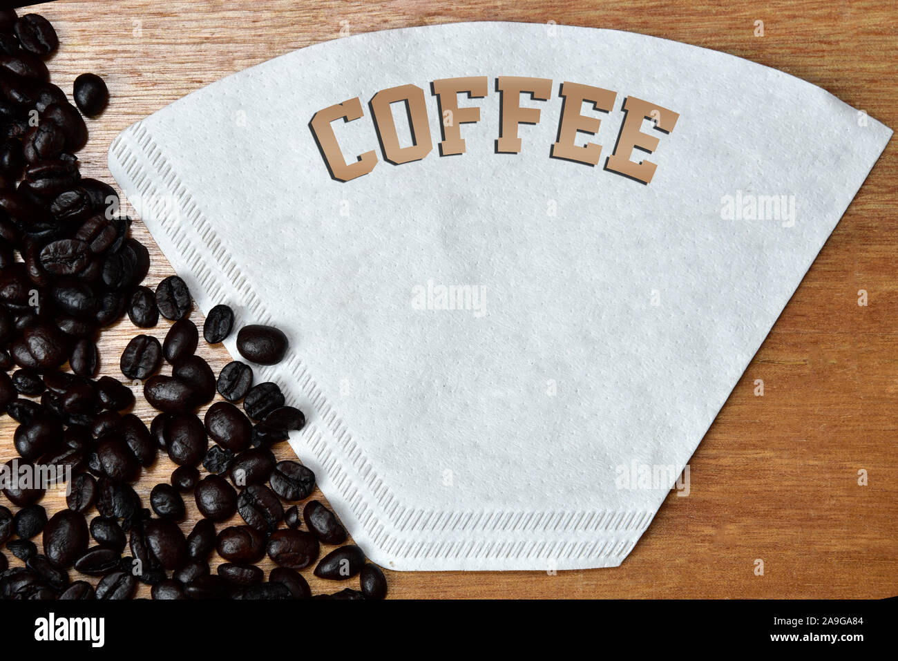 roasted coffee beans on the table with the word cafe. Stock Photo