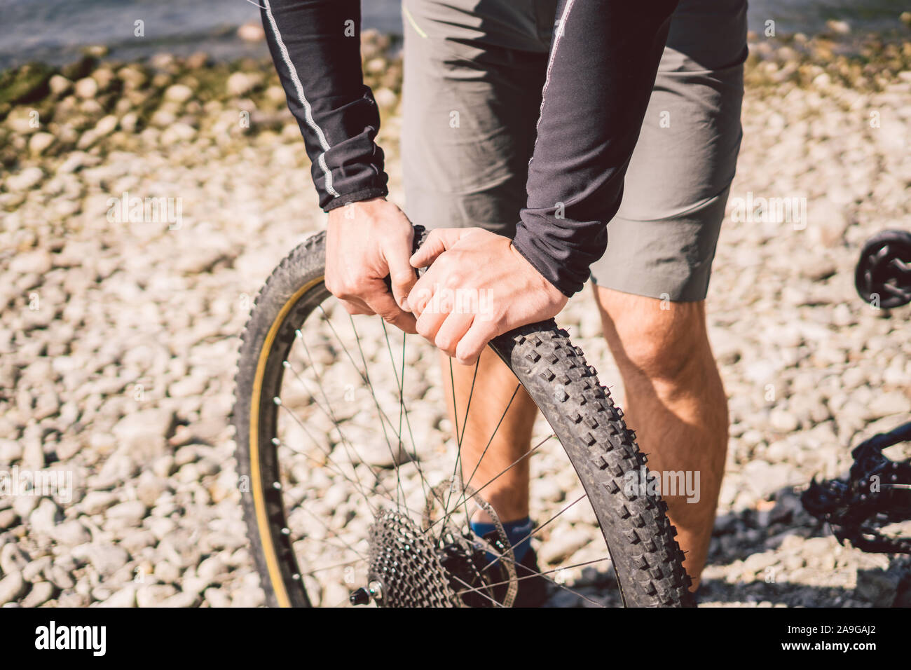 Bike Repair. Man Repairing Mountain Bike. Cyclist man in trouble rear