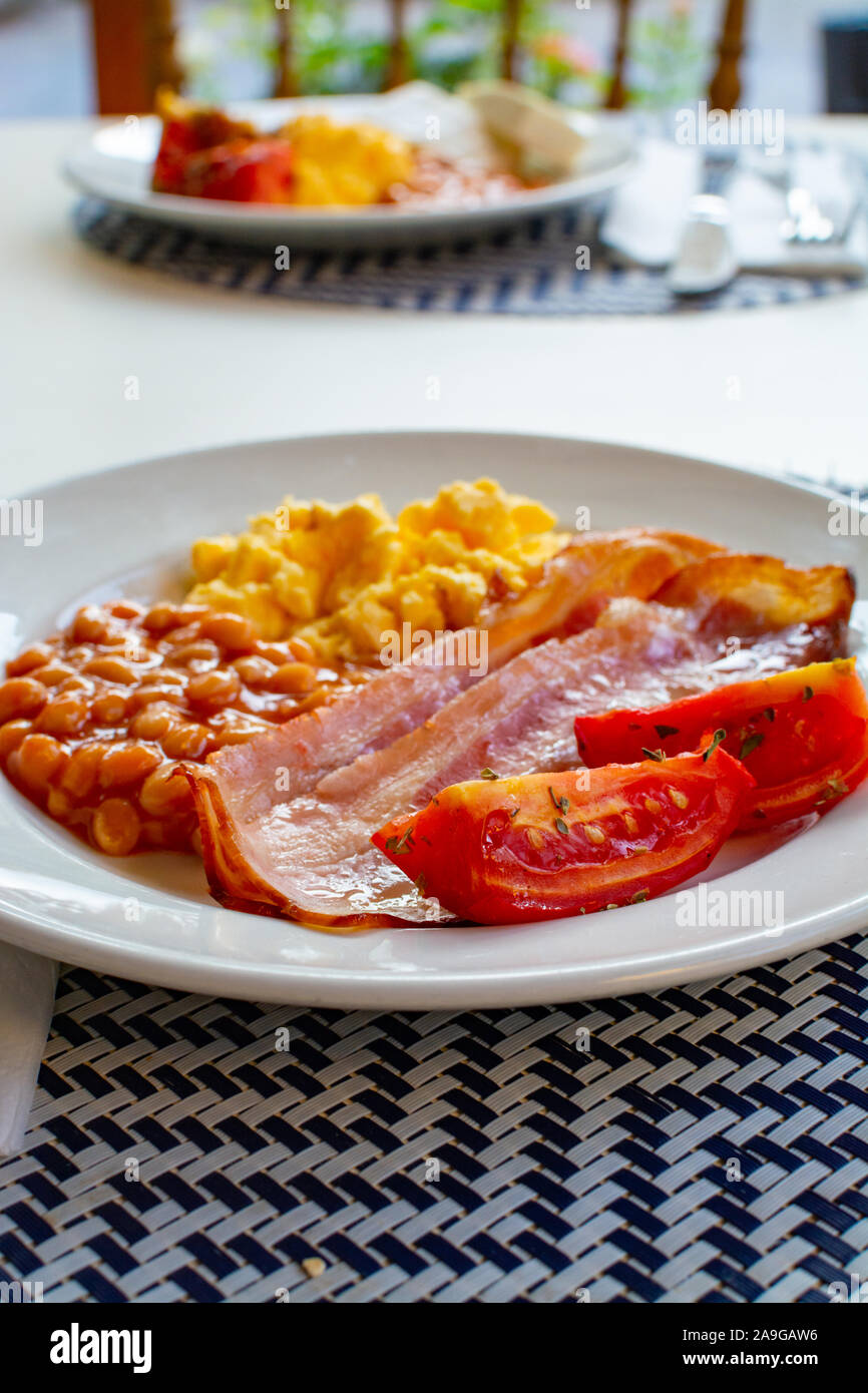 English Breakfast With Grilled Bacon Tomatoes Scrambled Eggs And Baked Beans In Tomato Sauce Served In Spain Stock Photo Alamy