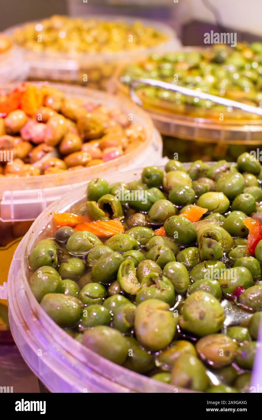 Homemade pickled green olives with garlic and spices in bucket on