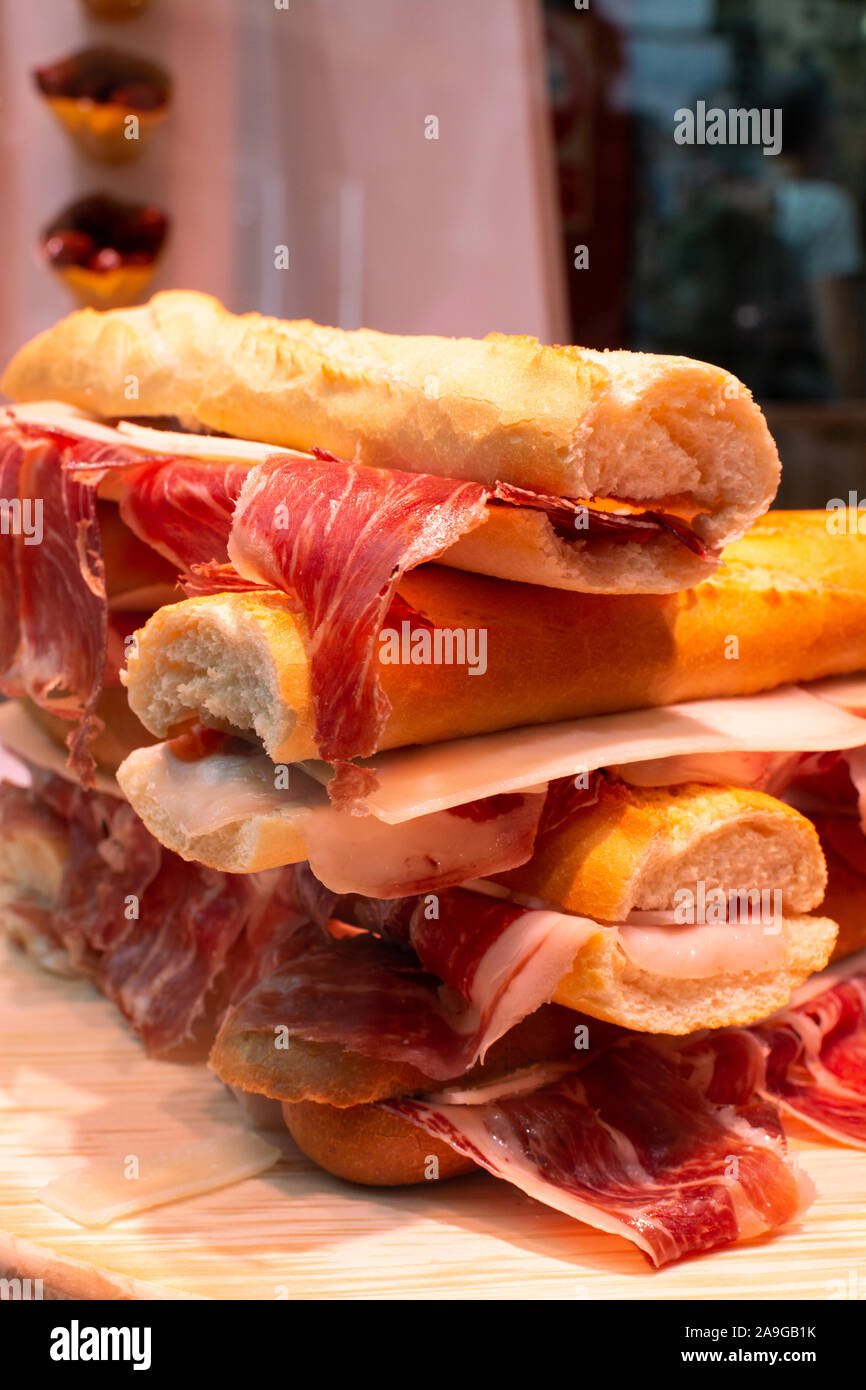 Spanish tapas street food, bocadillo fresh bread with jamon iberico