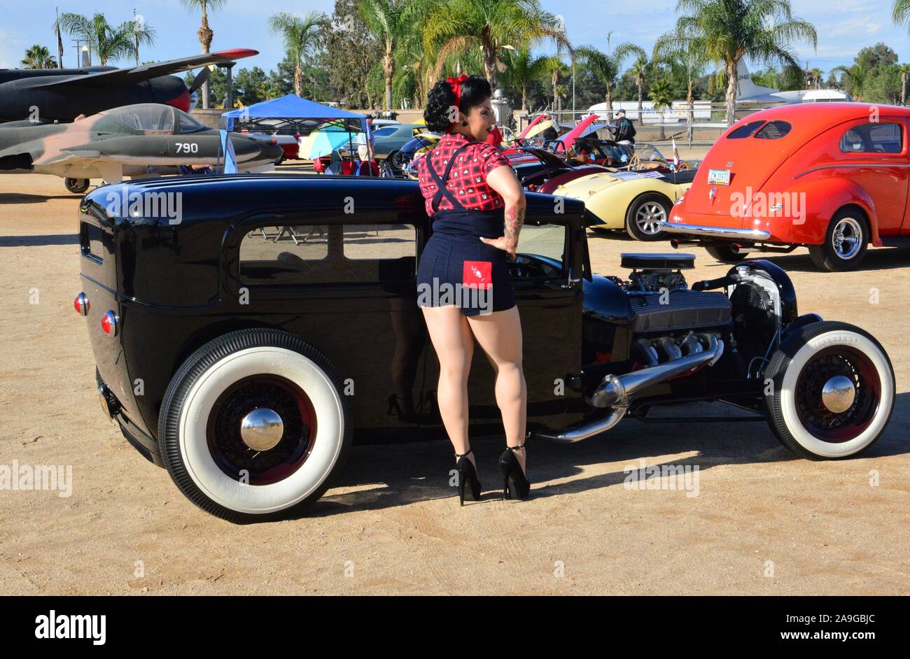 Betty Boo standing by a black lowrider Stock Photo - Alamy