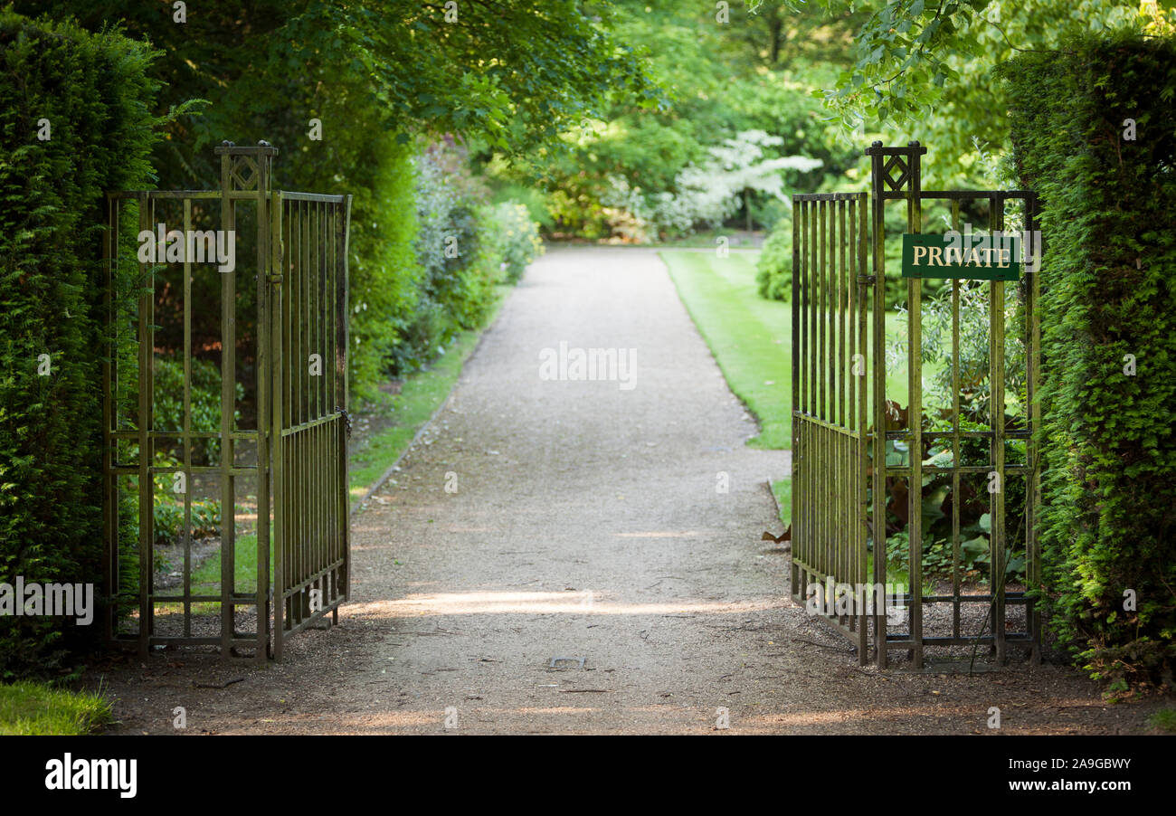 Private Garden. A gated English garden with an anonymous 'Private' sign. Stock Photo