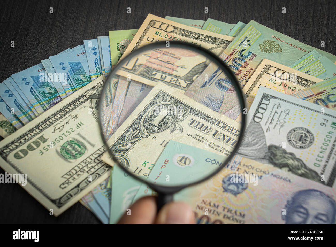 all money stack US dollar USD, VND, dong Pay, exchange vietnamese and  Magnifying glasson looking at numbers background Stock Photo - Alamy