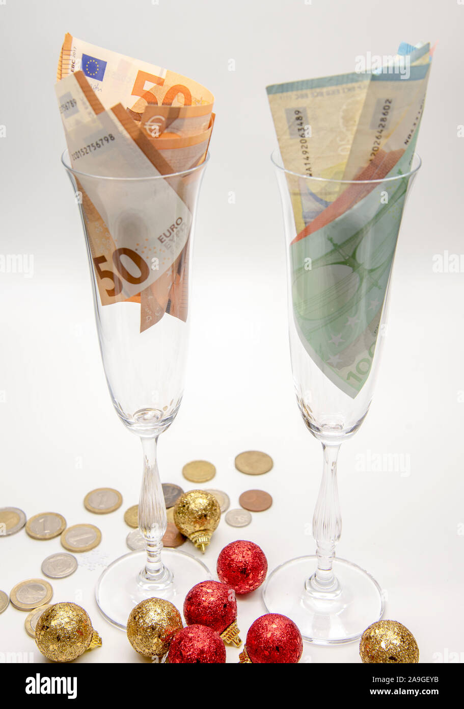 Two glasses with euros on a light background. Stock Photo