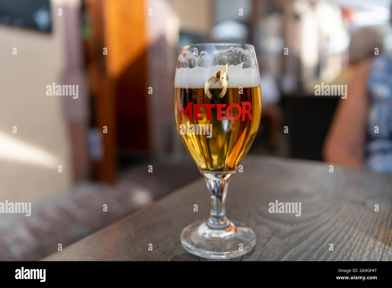 A glass of Meteor french lager or beer on a table in a bar in France