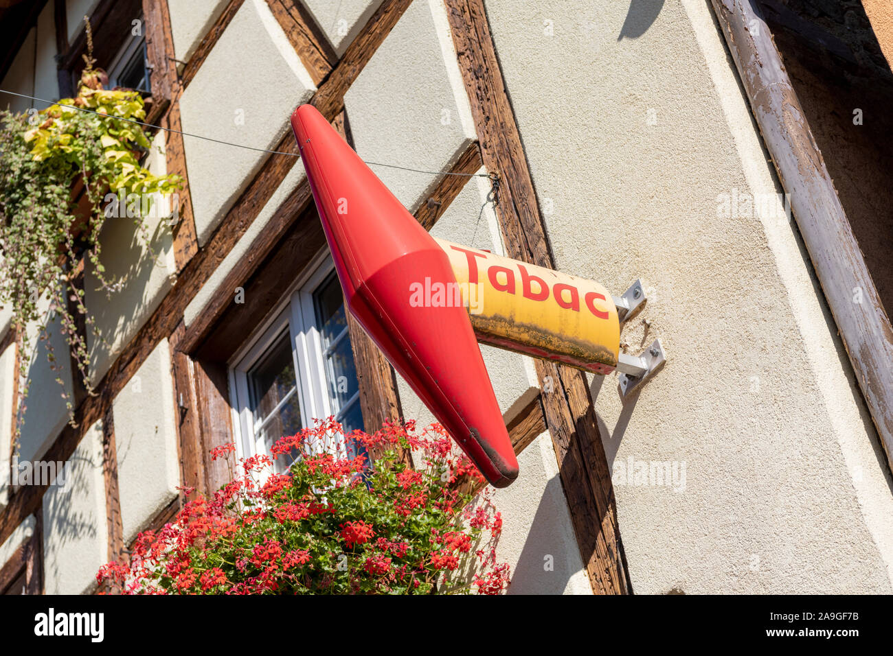 A french tabac or tabacconists shop sign on a wallin Eguisheim France Stock Photo