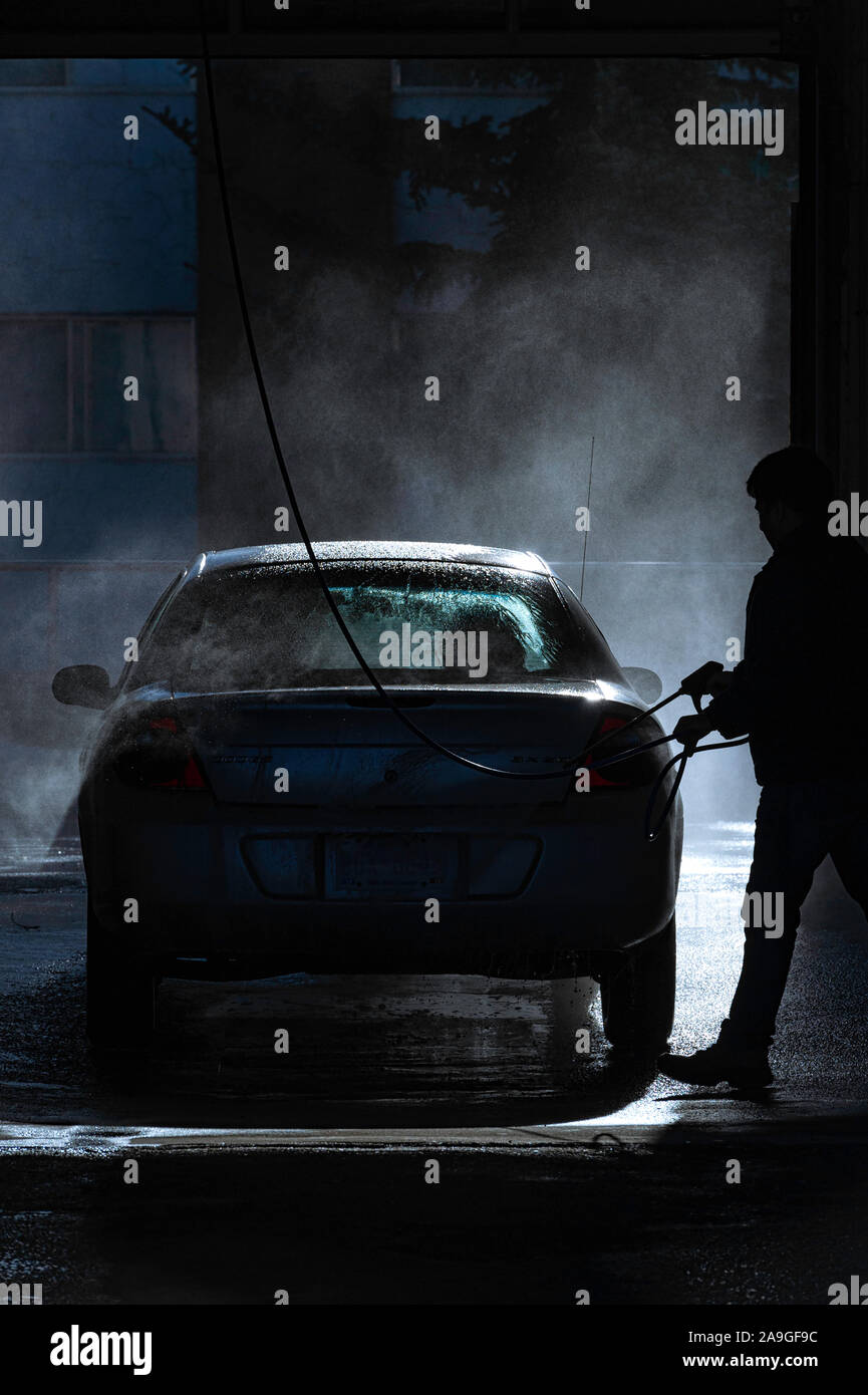 Man washing a car at a self serve car wash Stock Photo Alamy
