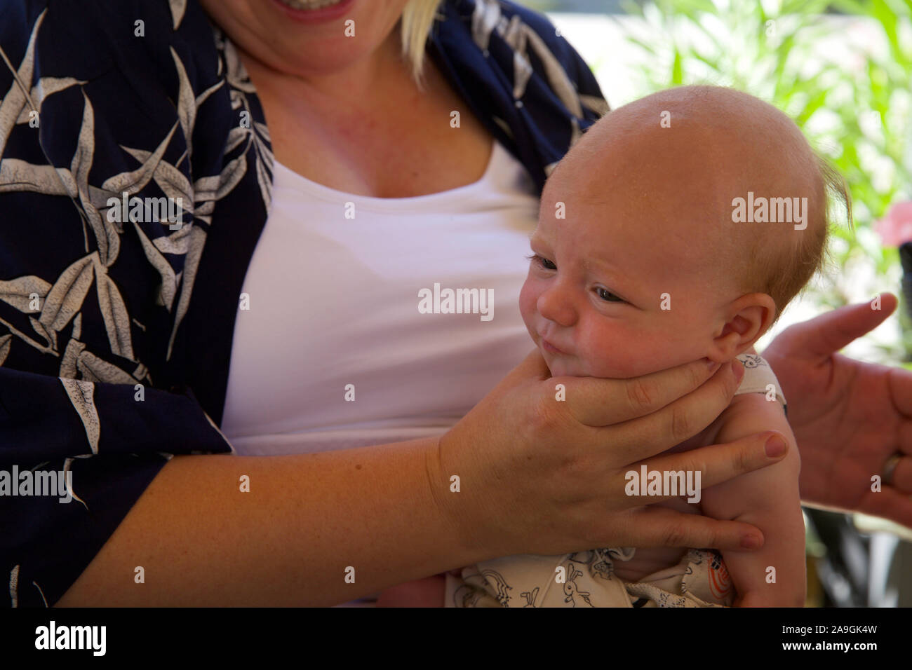 Baby being winded by her mother Stock Photo - Alamy