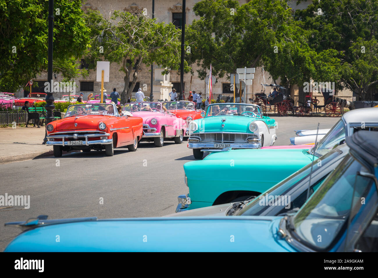 Havana, Cuba - July 23, 2018; typical colorful Cuban oldtimer classic cars driving and standing in a street of Habana during day time in summer Stock Photo