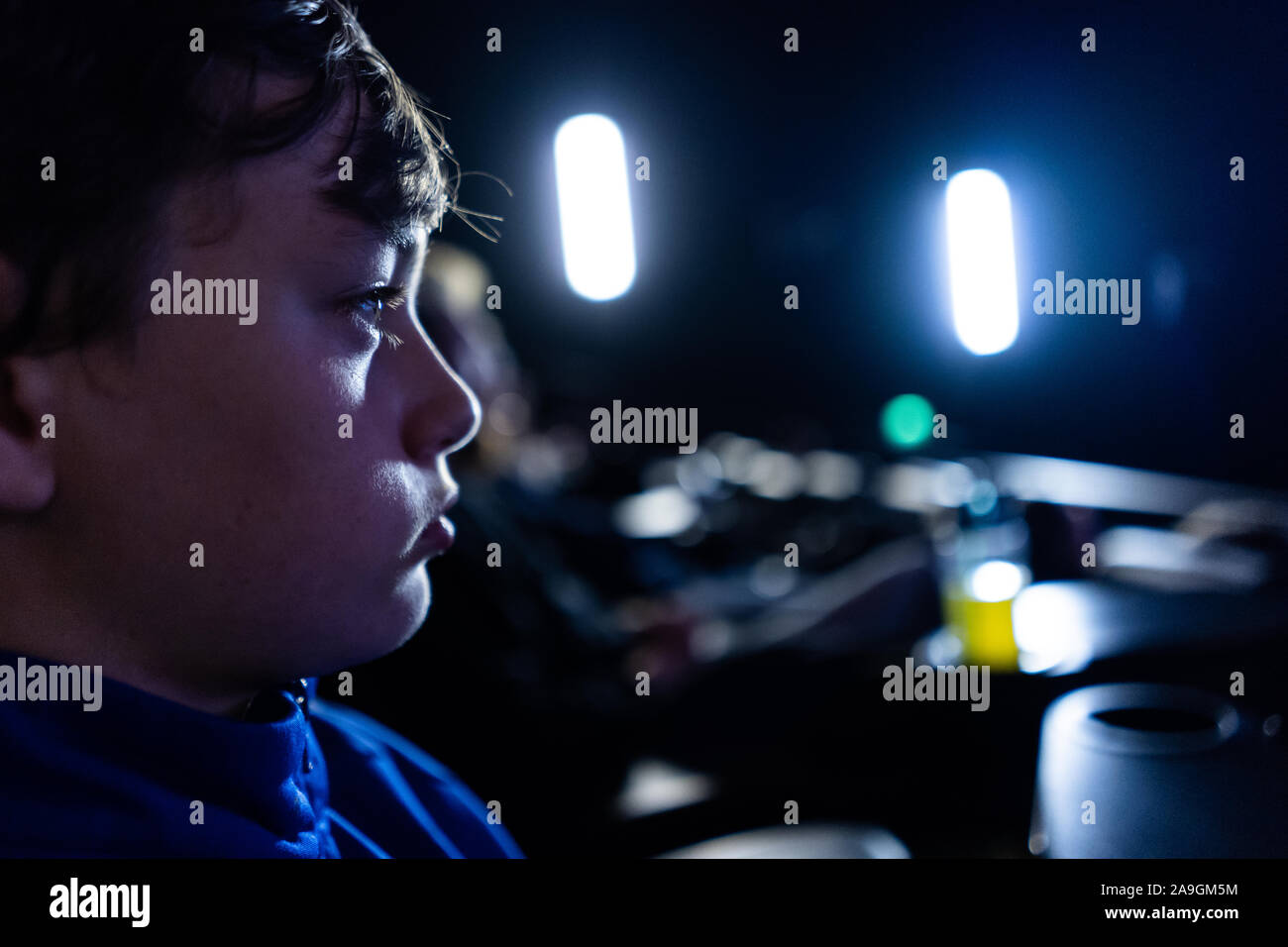 A young boy with ADHD, asperger syndrome, autism watching a film, movie at the cinema, concentrating and enjoying quiet time Stock Photo