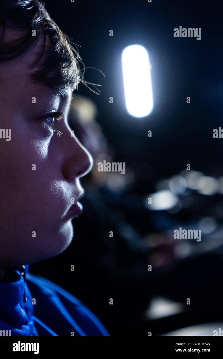A young boy with ADHD, asperger syndrome, autism watching a film, movie at the cinema, concentrating and enjoying quiet time Stock Photo