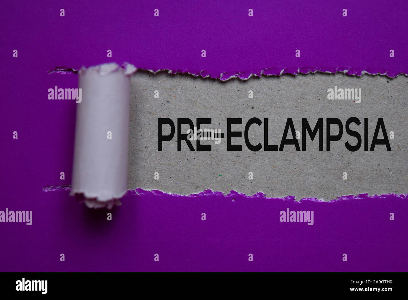 PreEclampsia Text written in torn paper. Medical concept Stock Photo