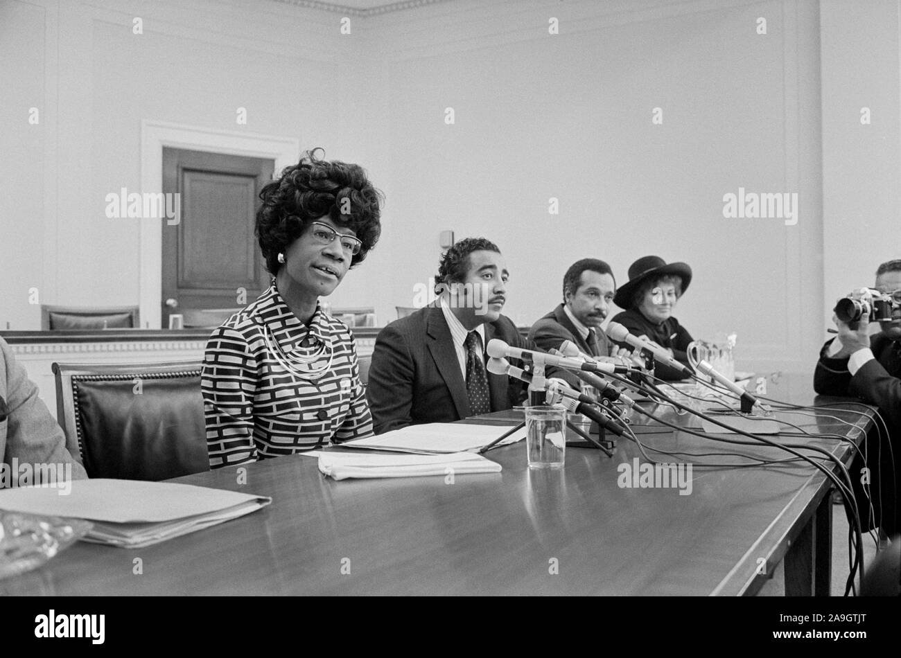 Democratic U.S. Congresswoman Shirley Chisholm Announcing her Candidacy for U.S. Presidential Nomination with Representatives Parren Mitchell, Charles Rangel, and Bella Abzug seated at Table with Microphones, Thomas J. O'Halloran, January 25, 1972 Stock Photo