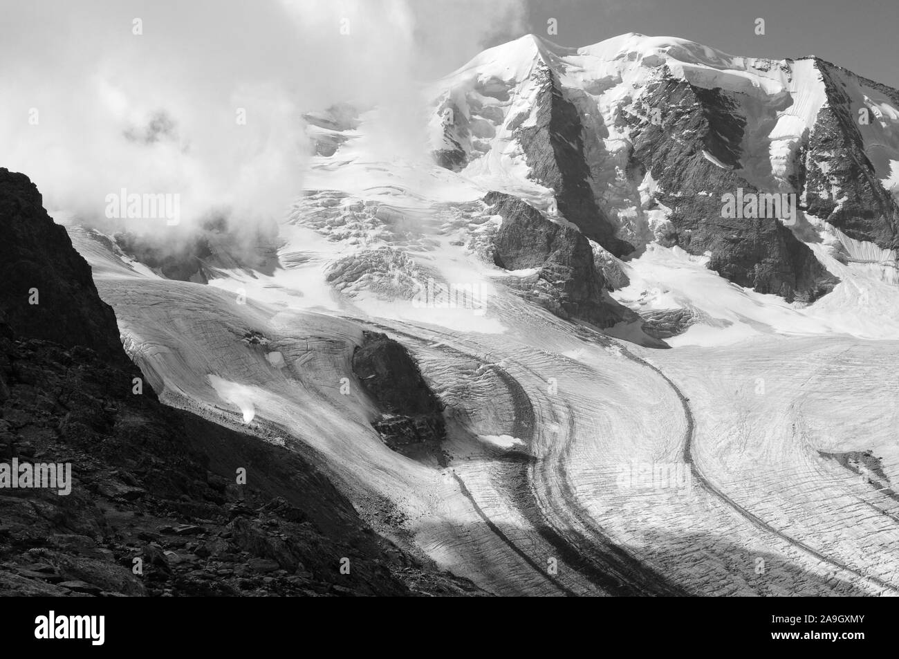 Swiss alps: Piz Palü peak and melting glaciers due to global clima change Stock Photo