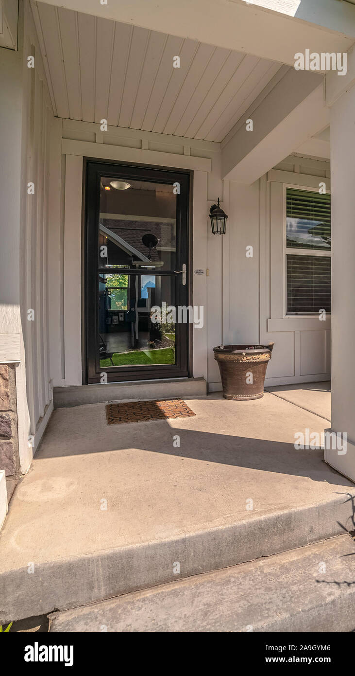 Vertical Covered porch and glass entrance door to a house Stock Photo ...