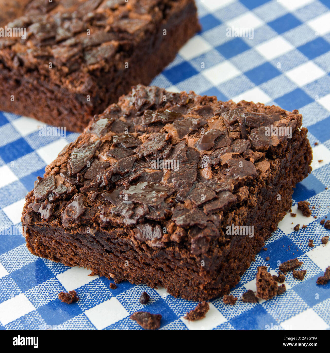 Two Brownies and checked background close up Stock Photo