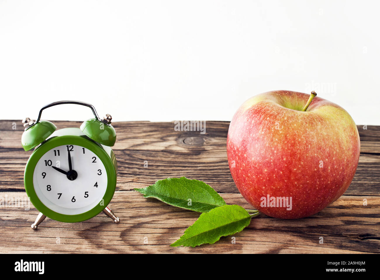 Break time clock and apple Stock Photo