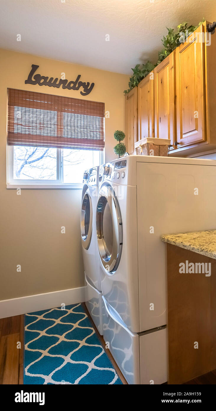 Vertical frame Laundry room of a home with washing machine against the