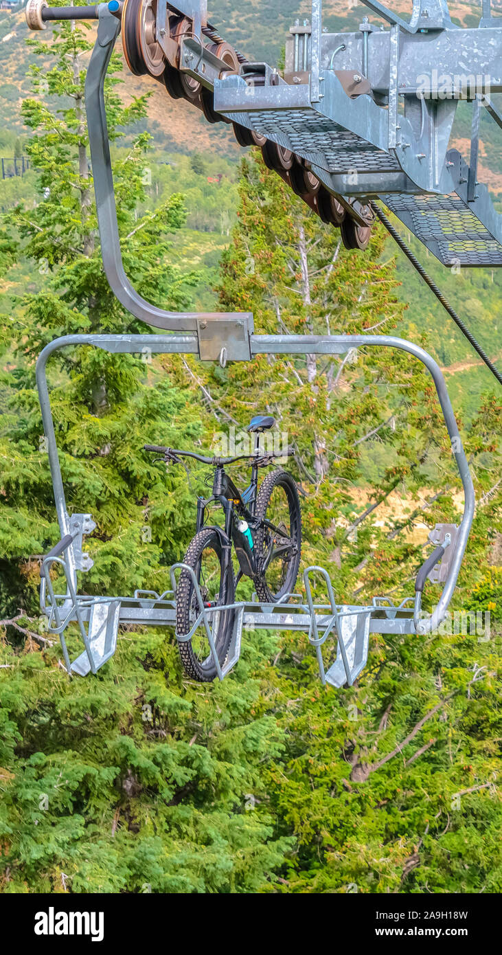Vertical frame Mountain bike on a lift against trees in Park City ski resort during off season Stock Photo Alamy