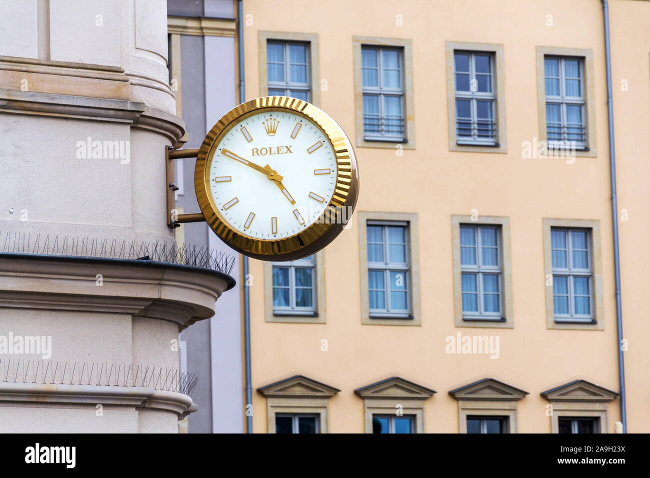 DRESDEN, GERMANY - APRIL 1 2018: Rolex Swiss luxury watch company logo on golden wall clock over the shop on April 1, 2018 in Dresden, Germany. Stock Photo