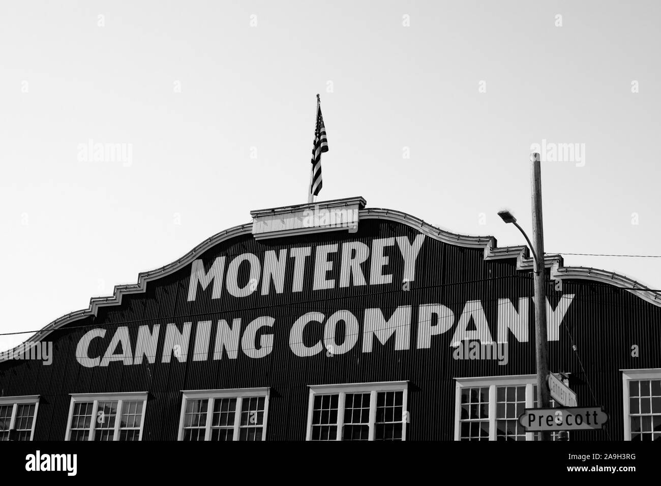 Monterey Canning Company corrugated iron building, Cannery Row, Monterey, California, United States of America. Black and white Stock Photo