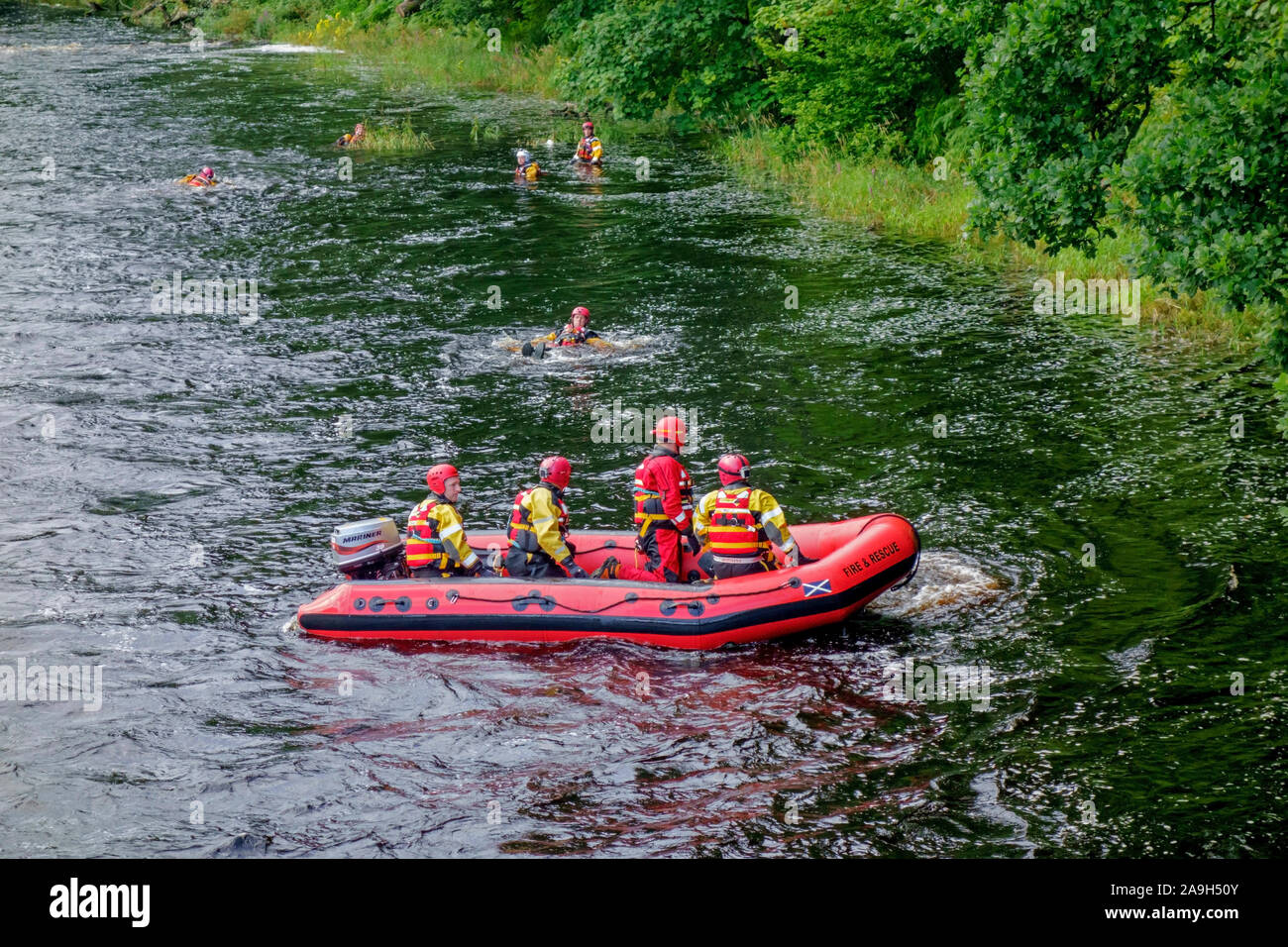 Scottish Fire and Rescue personnel on a water rescue training exercise in the River Cree at Newton Stewart, Dumfries and Galloway, Scotland. Stock Photo