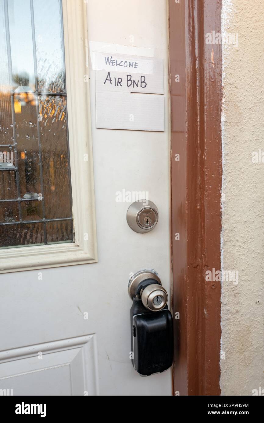 Close-up of hand drawn sign on door of a home reading Welcome AirBNB, indicating the home is made available for short term rental through the AirBNB website, Los Angeles, California, October 26, 2019. () Stock Photo