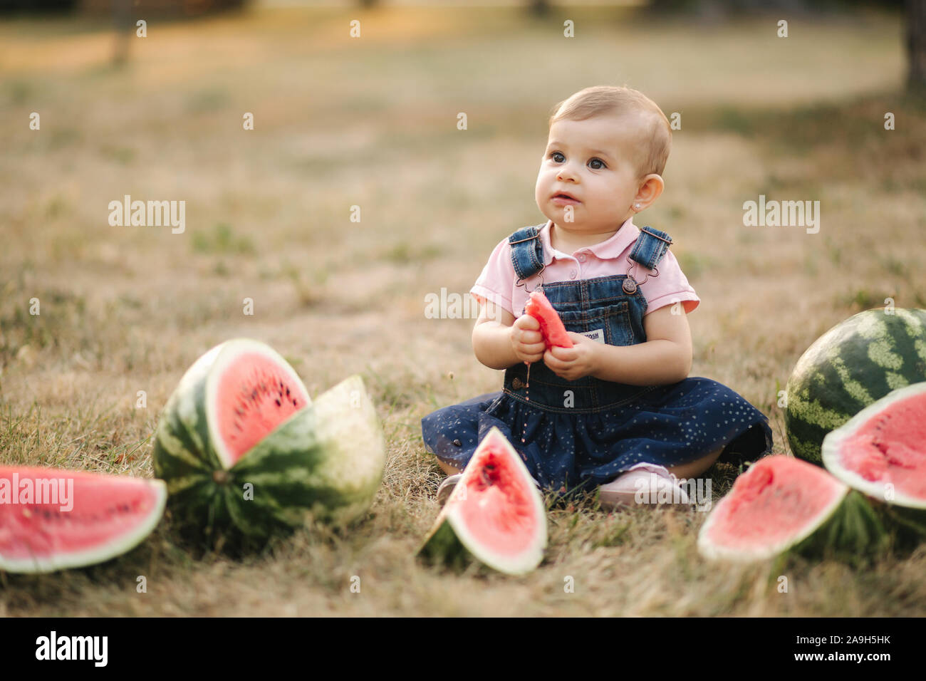 Cute Little Baby Girl Laughing With Watermelons Girl Dressed In Denim Dress Summer Portrait Of Child And Watermelon Outdoors Adorable Baby Eat Frui Stock Photo Alamy