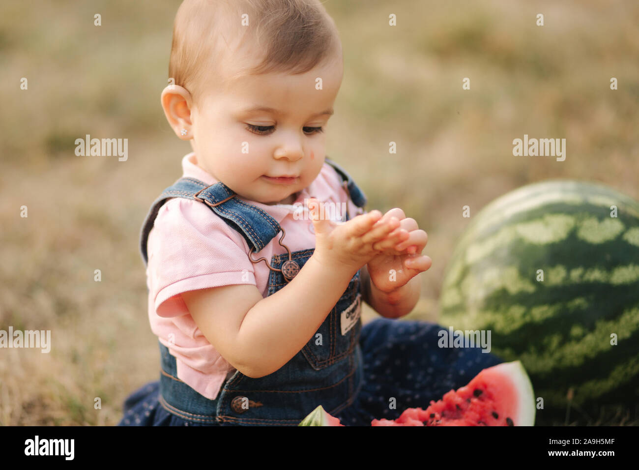 Close Up Of Adorable Baby Girl Eat Watermelon Stylish Baby In