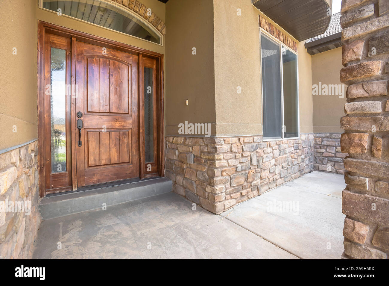 Home Porch And Brown Wood Front Door With Sidelights And