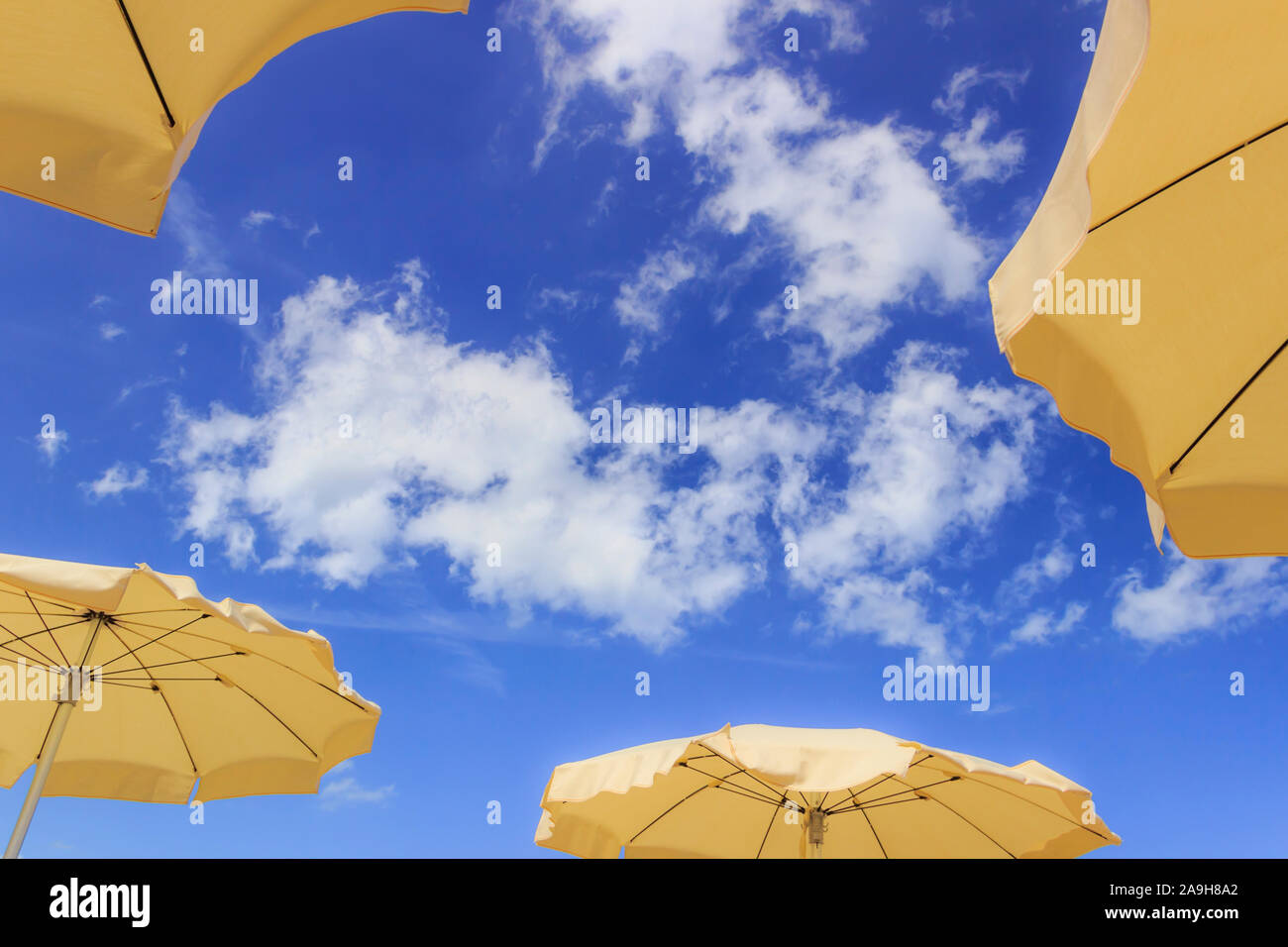 Umbrellas on blue sky with clouds Stock Photo Alamy