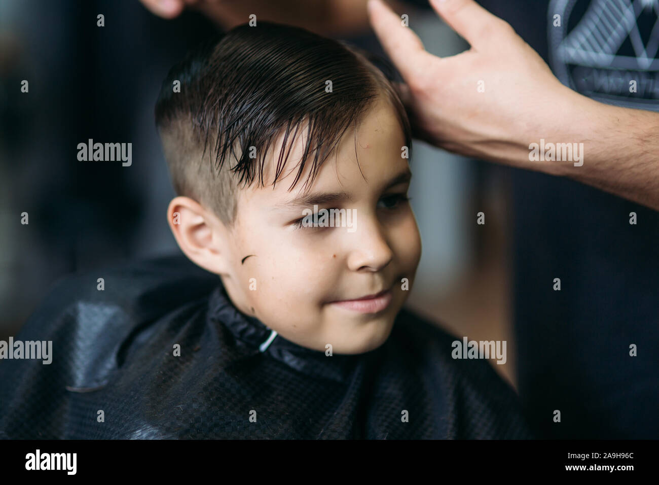 The Boy Getting Haircut By Scissor In Barbershop Barber Use