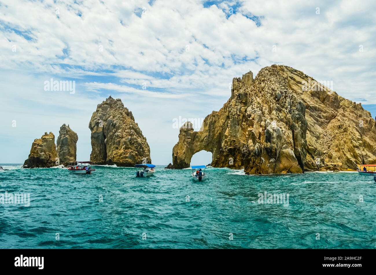 Tourists visiting by boat The Arch and Land's End at Sunset, Cabo San ...