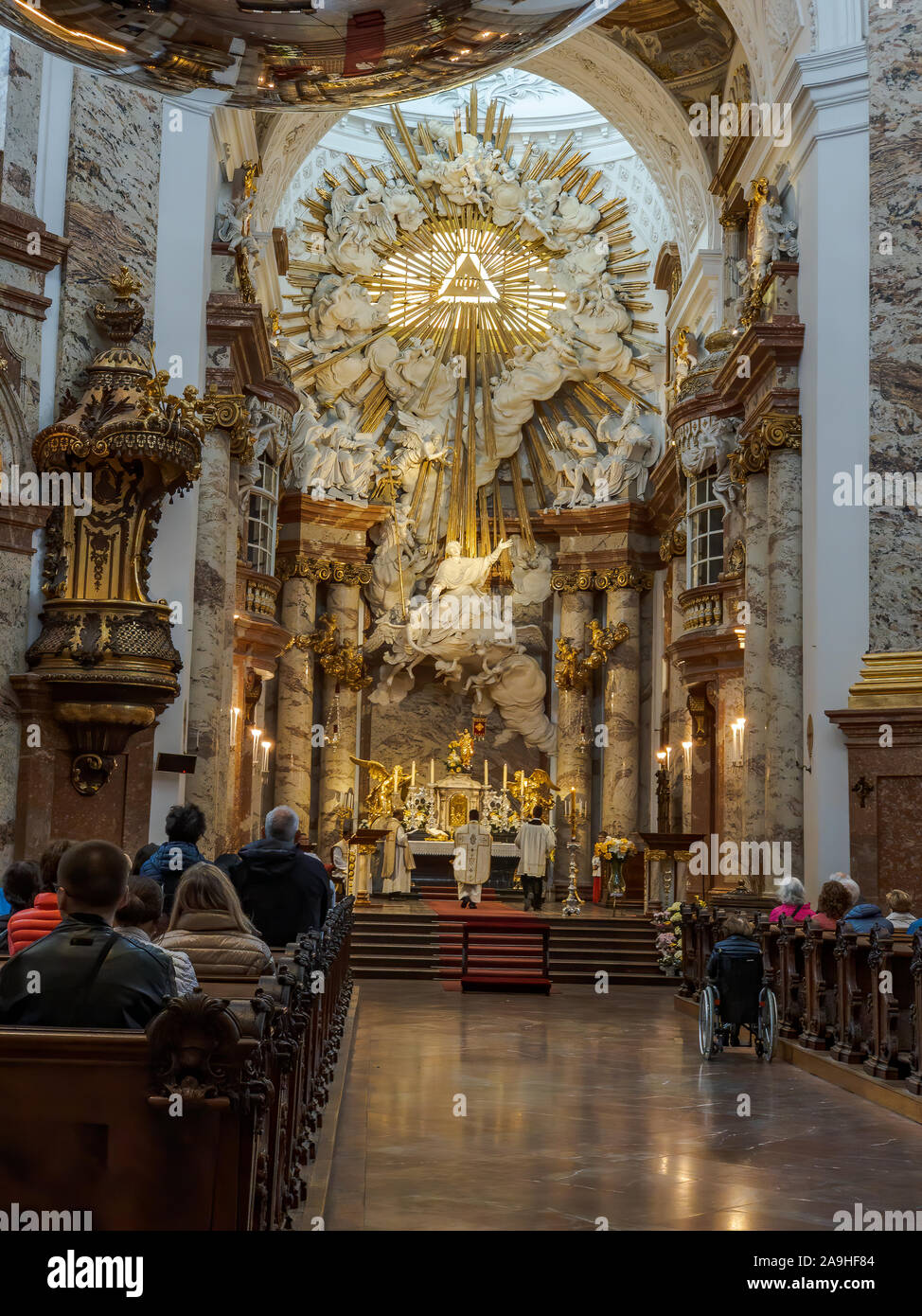 Vienna Austria April 28 2019 People Sit Inside Karlskirche St Charle S Church For A Mass Service Stock Photo Alamy