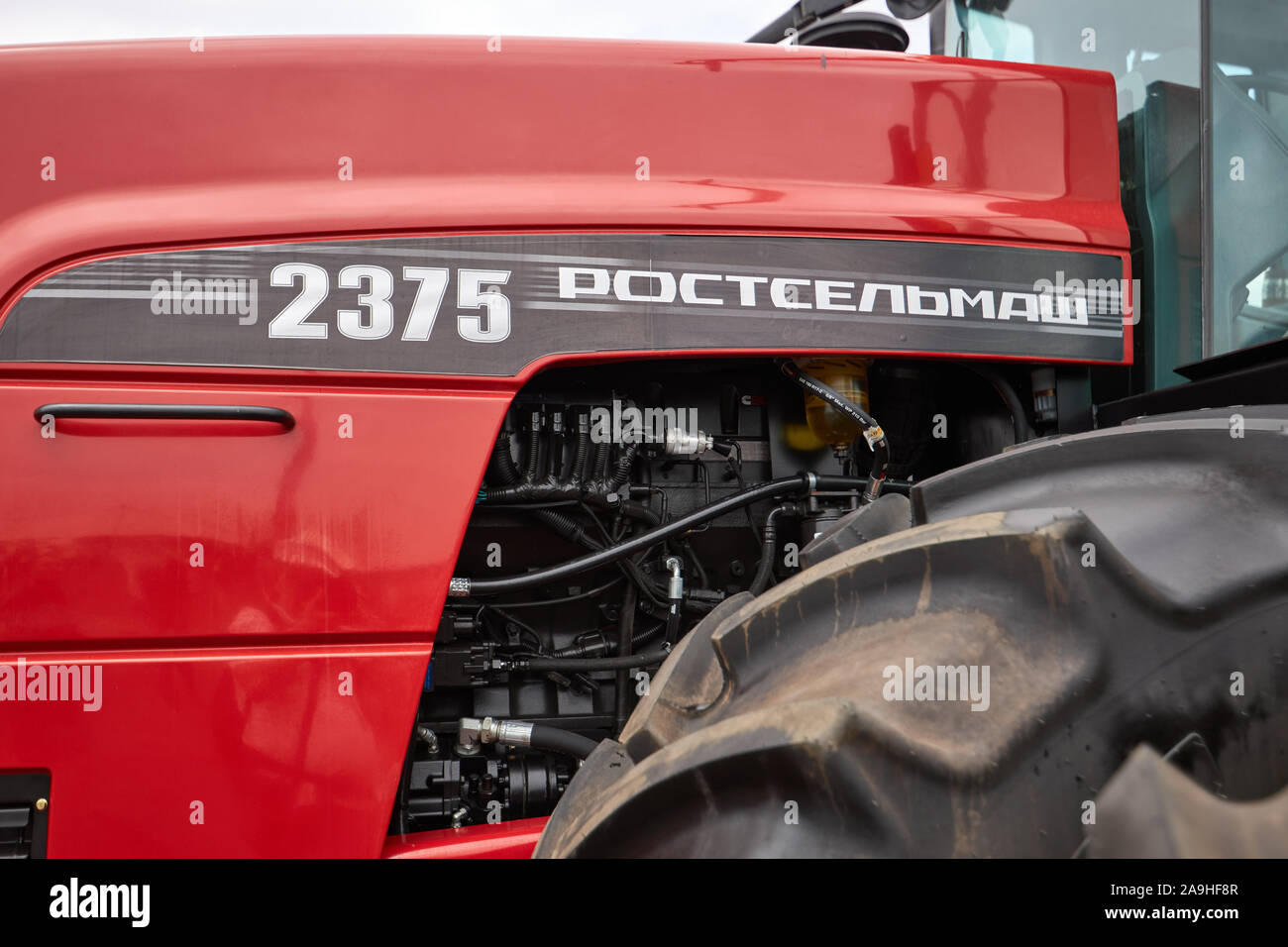 Sambek, Rostov Region, Russia, June 28, 2019: View of the engine compartment and the huge wheel of the modern Rostselmash RSM-2375 tractor Stock Photo