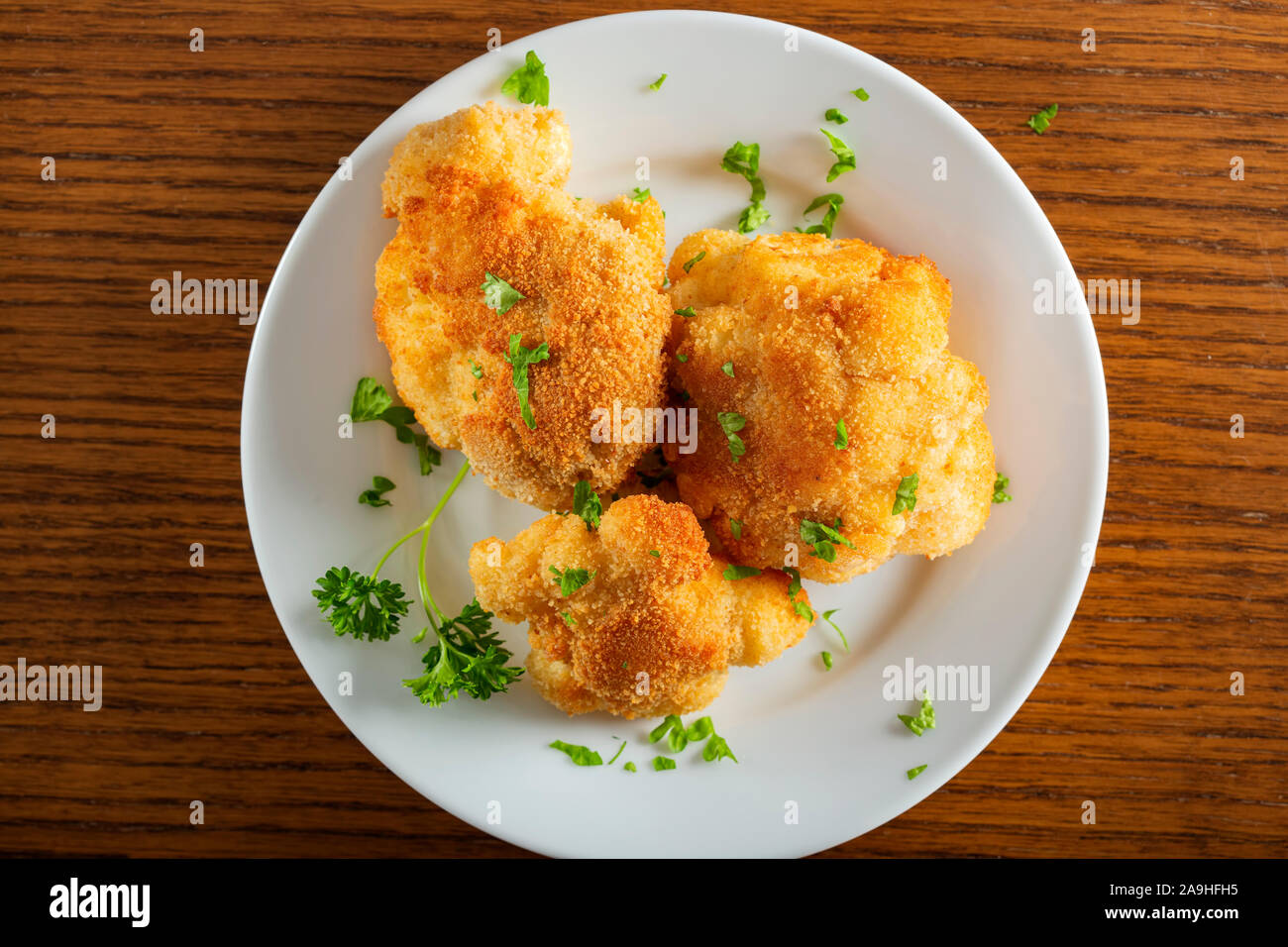 Cauliflower fried on plate with chopped parsley - top view Stock Photo